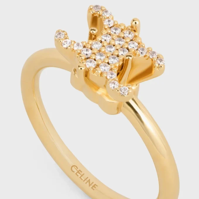 Anillo solitario Triomphe con brillos de strass y latón con acabado dorado Anillo solitario Triomphe con brillos de strass y latón con acabado dorado