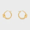 Aros dobles con nudo en latón con acabado dorado Aros dobles con nudo en latón con acabado dorado