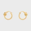 Aros pequeños Knot en latón con acabado dorado Aros pequeños Knot en latón con acabado dorado