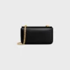 Bolso de hombro con cadena Claude en piel de becerro brillante