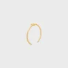 Brazalete asimétrico Triomphe en latón con acabado dorado