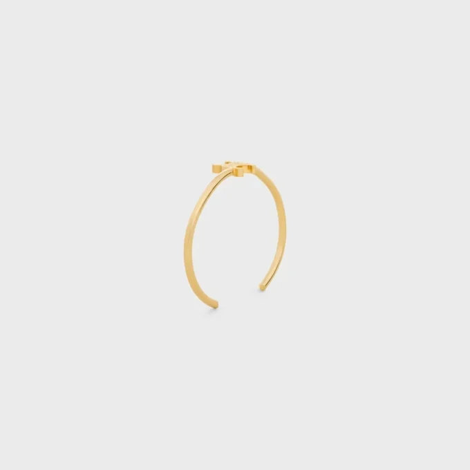 Brazalete asimétrico Triomphe en latón con acabado dorado