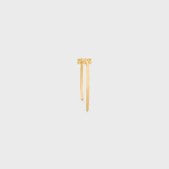 Brazalete asimétrico Triomphe en latón con acabado dorado