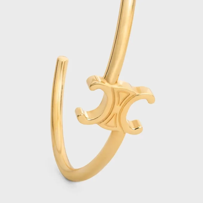 Brazalete asimétrico Triomphe en latón con acabado dorado