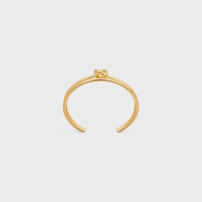 Brazalete doble con nudo en latón con acabado dorado Brazalete doble con nudo en latón con acabado dorado