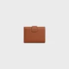 Cartera Nino con correa fina en piel de becerro granulada flexible