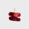 Charm Triomphe con pompón en piel de oveja bordada y piel de becerro Charm Triomphe con pompón en piel de oveja bordada y piel de becerro