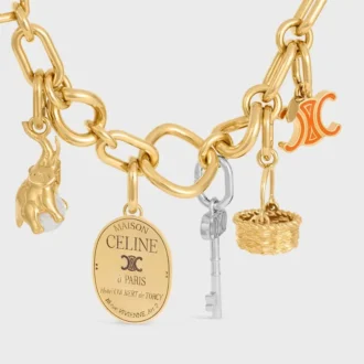 Charms CELINE Triomphe en esmalte y latón con acabado dorado