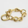Charms Modern Thin Gourmette en latón con acabado dorado Charms Modern Thin Gourmette en latón con acabado dorado