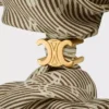 Goma para el pelo CELINE Triomphe Diagonale en seda y latón con acabado dorado Goma para el pelo CELINE Triomphe Diagonale en seda y latón con acabado dorado